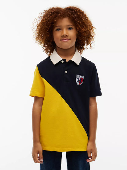 Polo elástico con bloques de color y logo del escudo