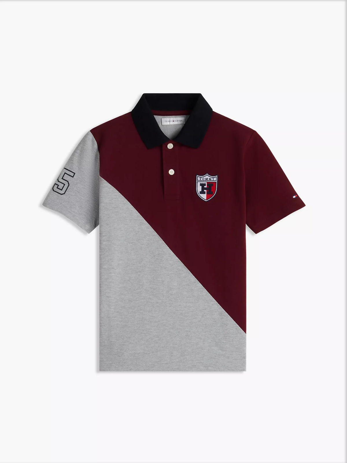 Polo elástico con bloques de color y logo del escudo